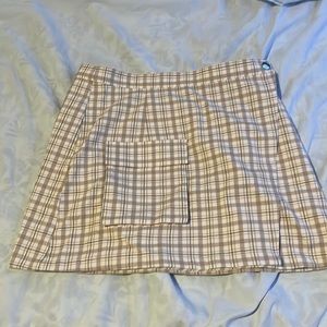 Cute skirt has a button and a clip on